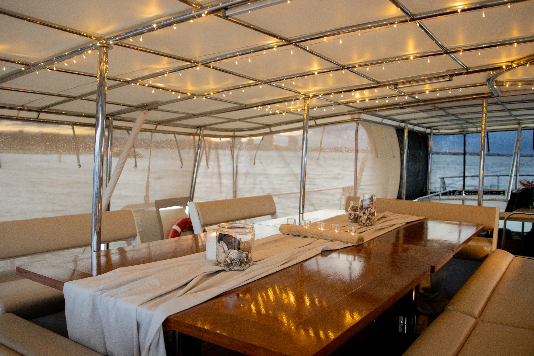 The Captain's Table set for a banquet on a Gold Coast sailing voyage aboard VOYŌ