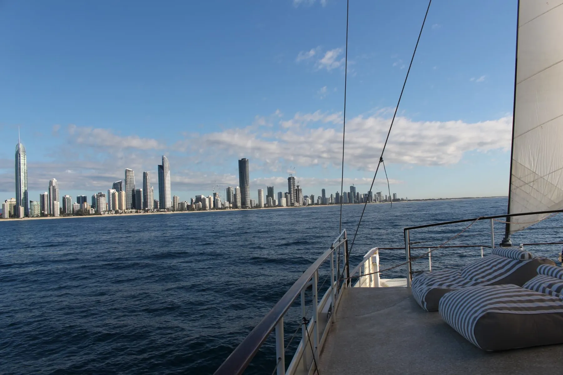 Sails up and the Surfers Paradise skyline from the deck on a Gold Coast sailing voyage