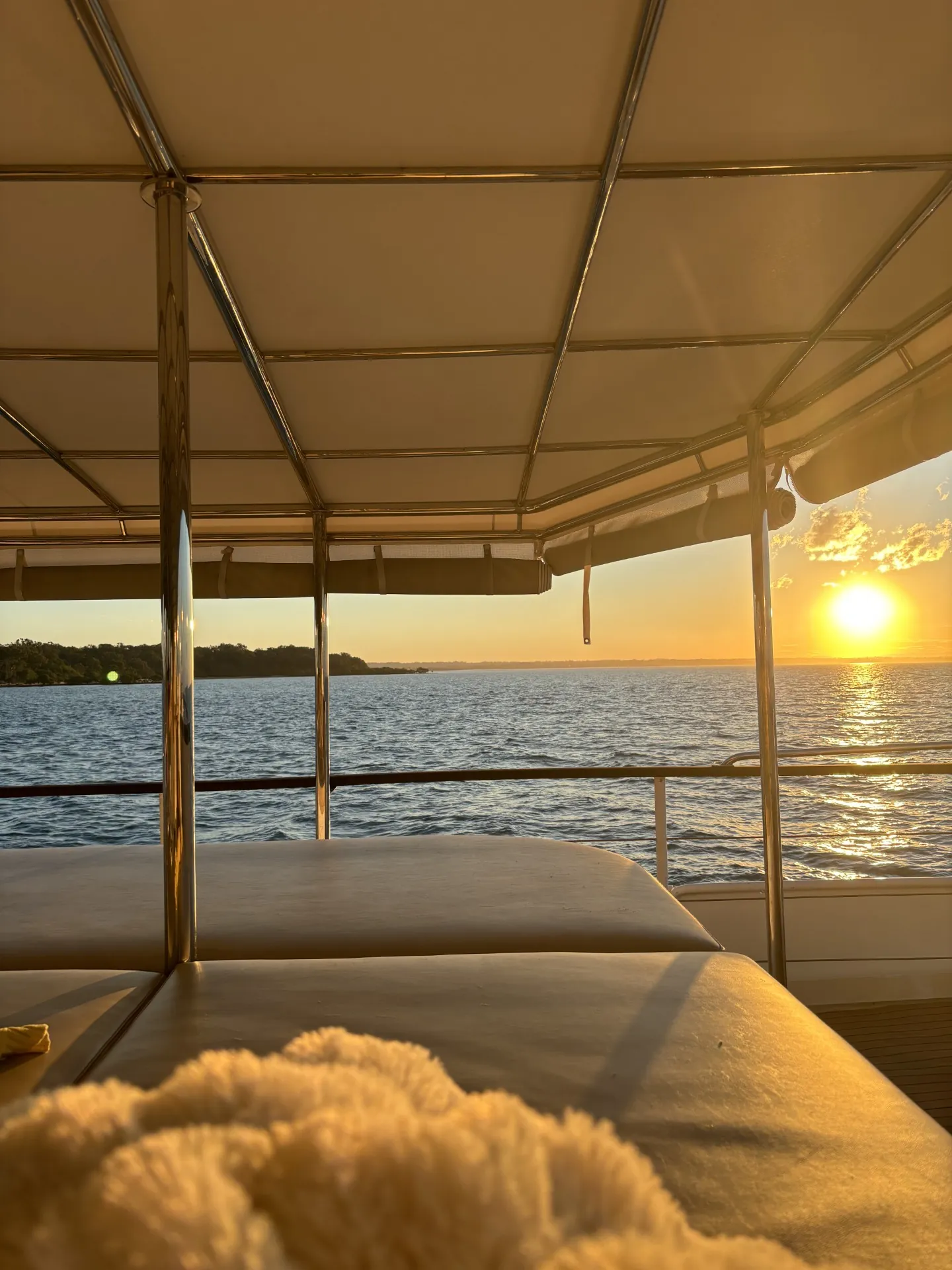 Golden hour from the daybed on a Gold Coast sailing sunset voyage aboard VOYŌ