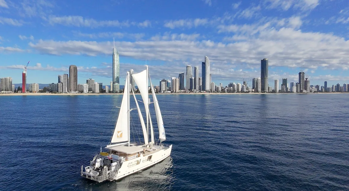 Gold Coast sailing superyacht VOYŌ heading toward the Surfers Paradise skyline